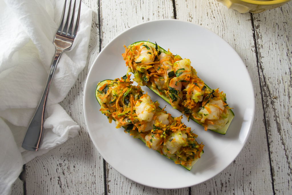 These shrimp stuffed zucchini boats are a great twist on an everyday vegetable. Paleo, gluten free, and whole 30 approved! These are a show stopper! - OCD Kitchen