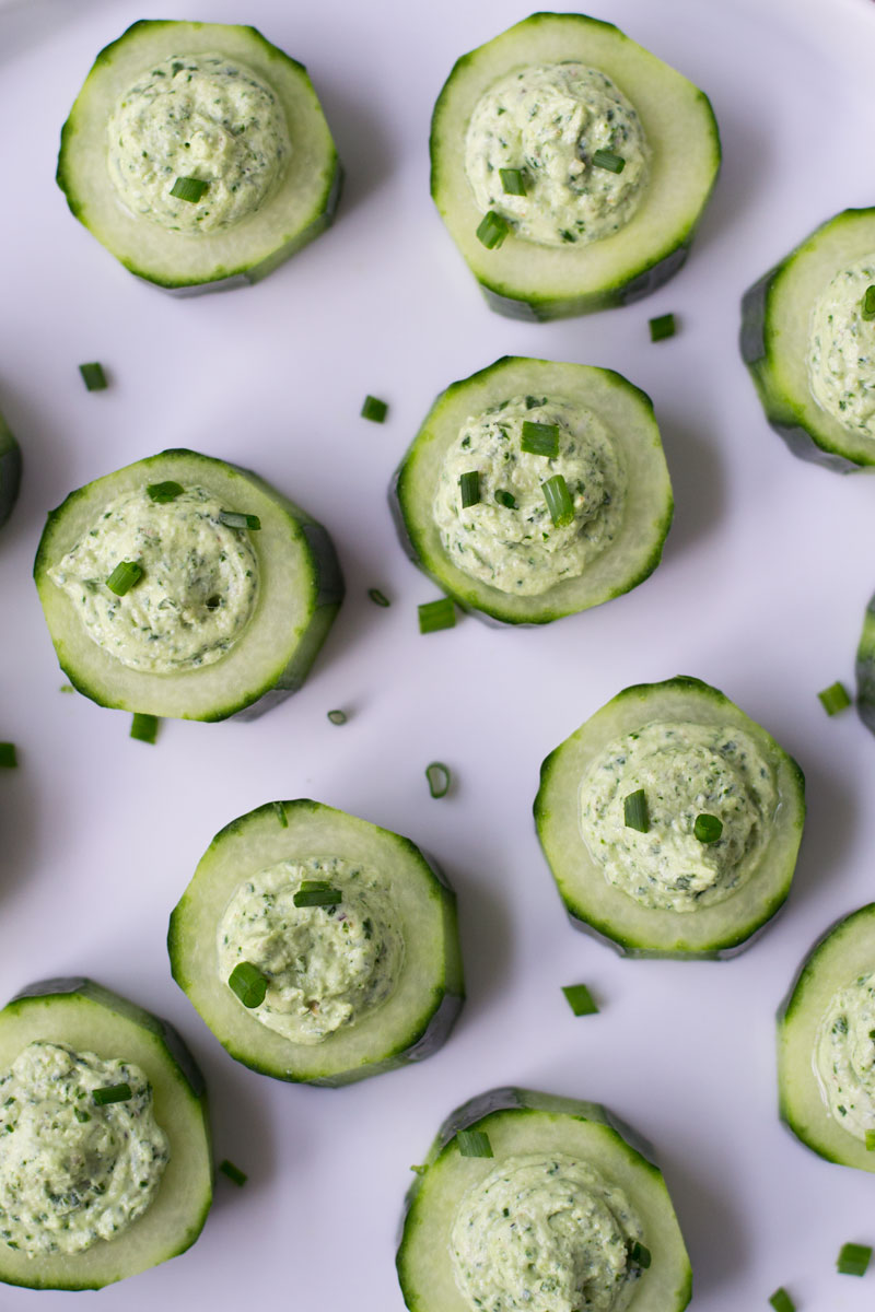Easy no cook dinner party appetizer. Creamy tangy goat cheese with herbs in a cute cucumber cup. 